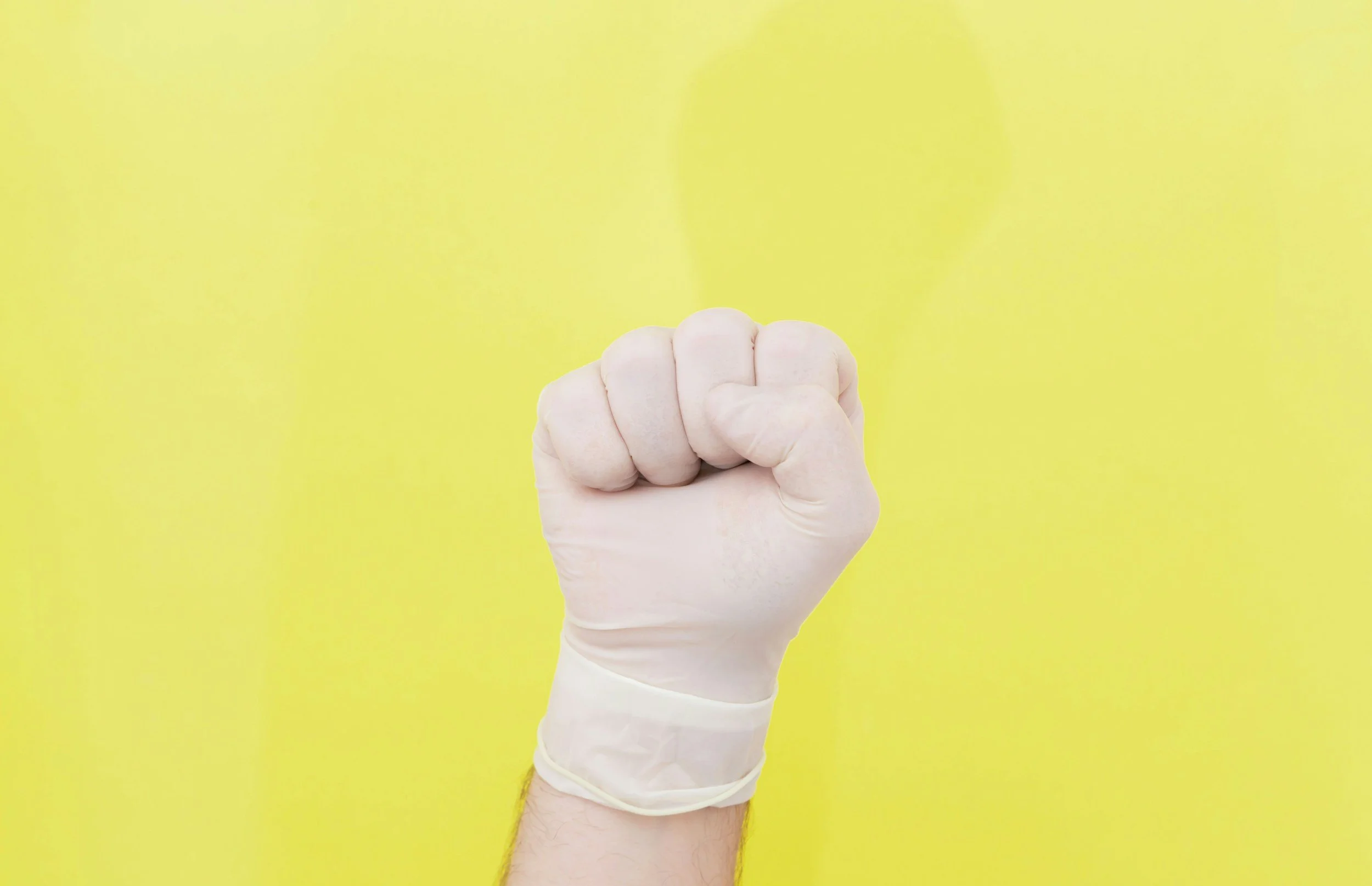 a person holding their fist up with a glove on it